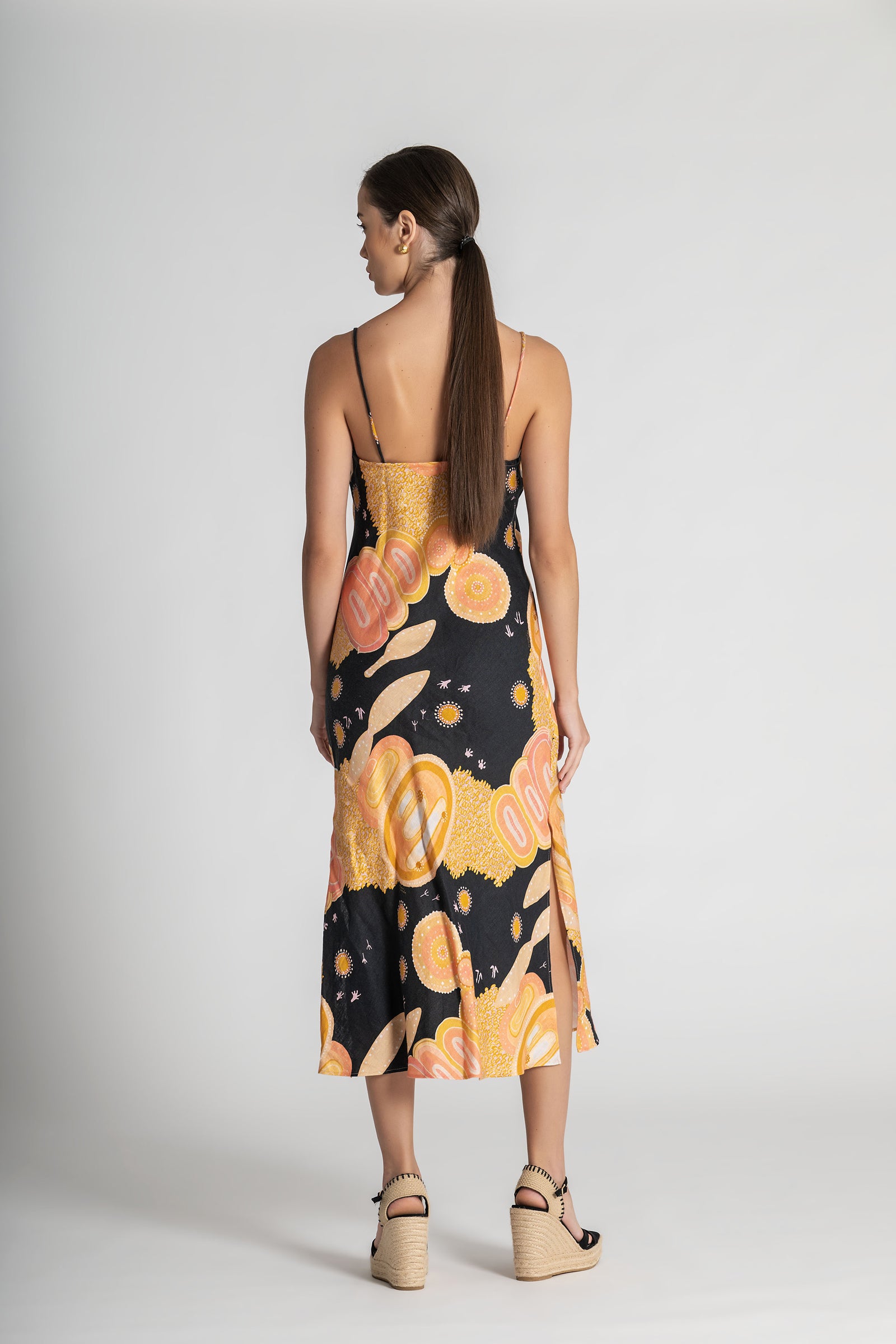 Woman wearing a floral dress with a black background on a white background